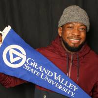 holding grand valley state university flag